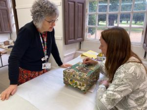 Dr Susan Kay-Williams and Anne Butcher examining embroidery box