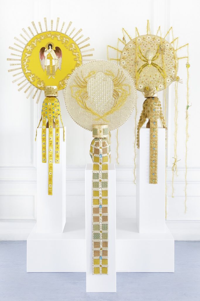 Golden sun embroidery display of three items