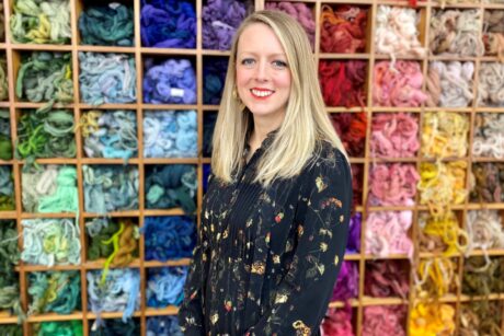 Eleri in front of multi coloured thread